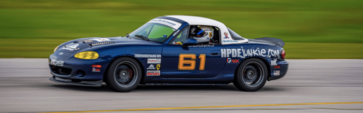 Blue Miata race car on track