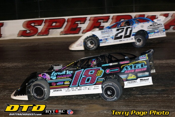 Race cars compete on dirt track