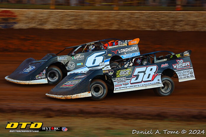 Two dirt sprint cars racing