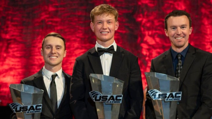 Men display racing awards posing