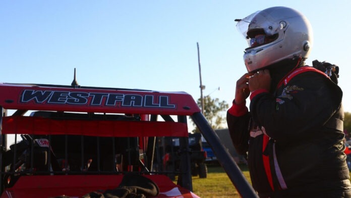 Racecar driver wearing protective helmet