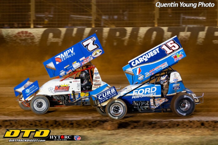 Race cars competing on dirt track