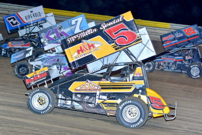 Yellow sprint car racing dirt oval