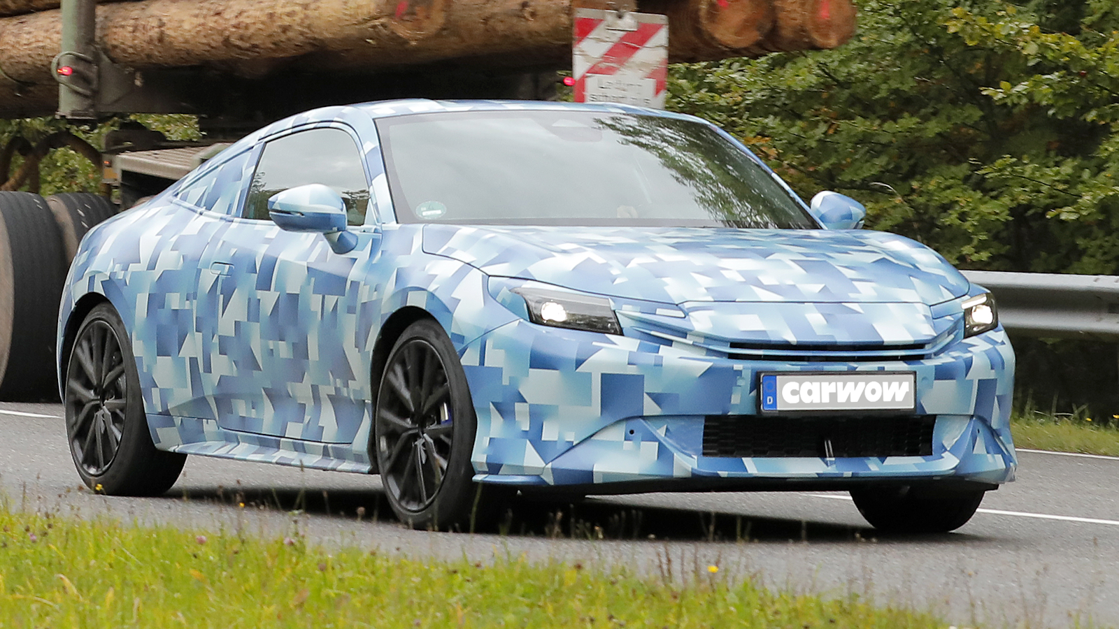 Blue Honda Prelude driving on road