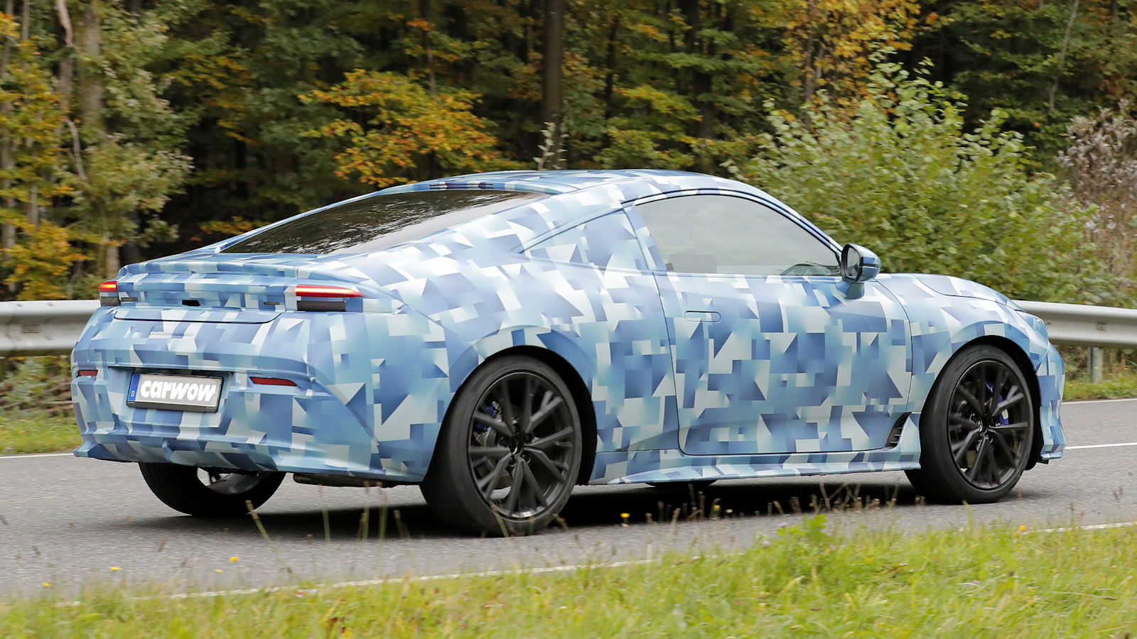 Blue Honda Prelude driving on road