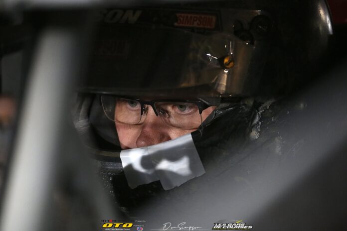 Race car driver wearing helmet