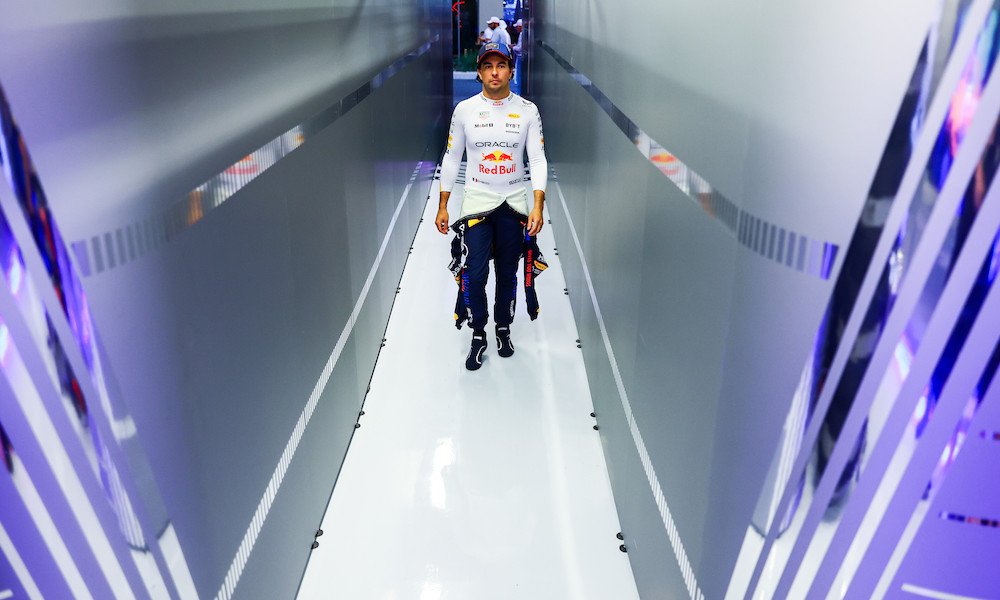 Racing driver walking in paddock hallway