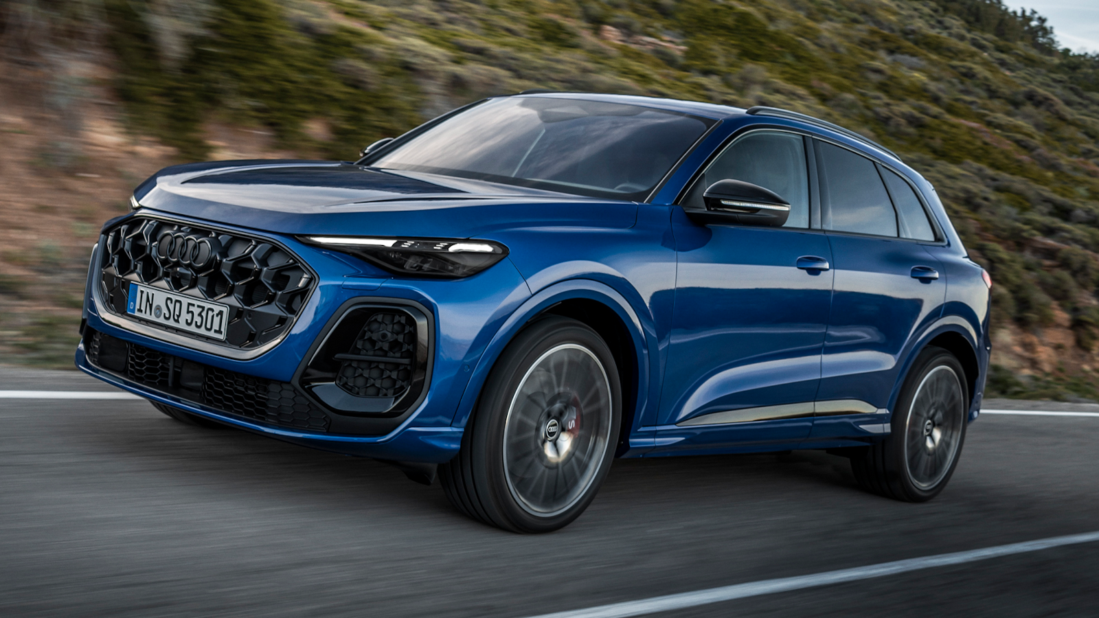 Blue Audi SQ5 driving on road