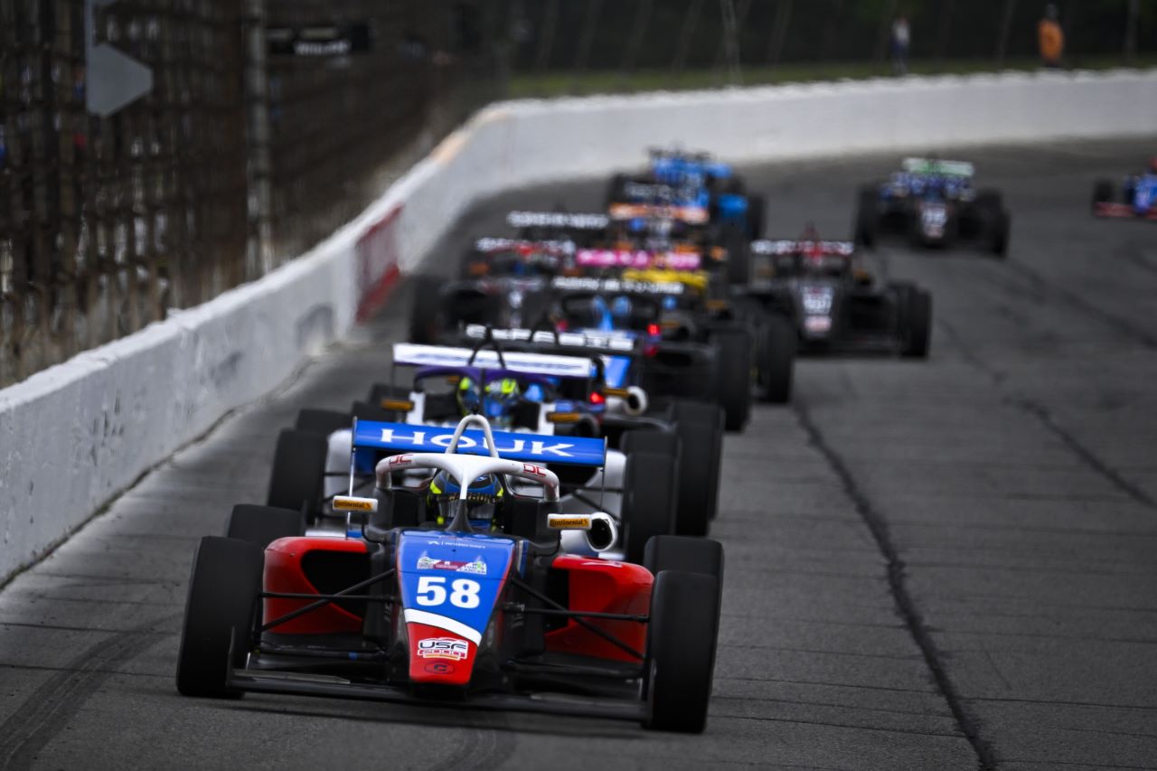 Red-blue IndyCar racing on track