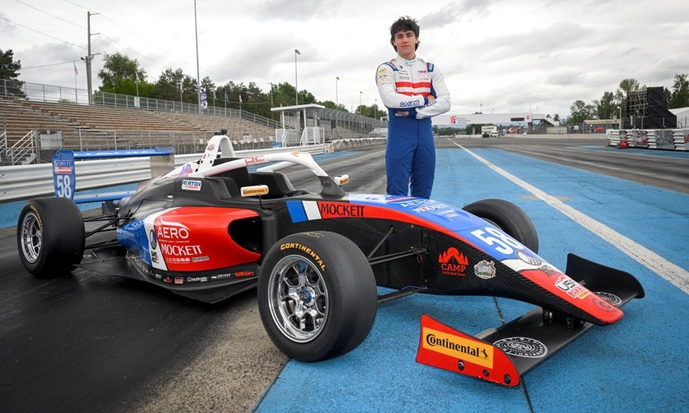 Driver next to Formula One car