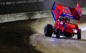 Red sprint car racing on dirt