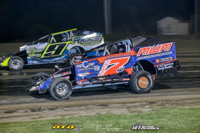 Dirt track racers battle side-by-side