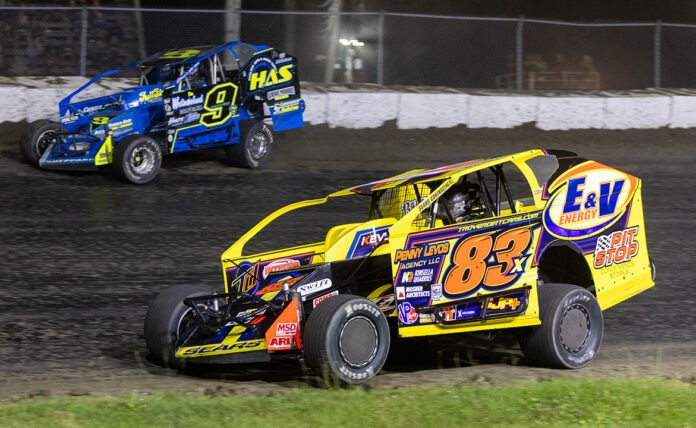 Two dirt track racers competing closely