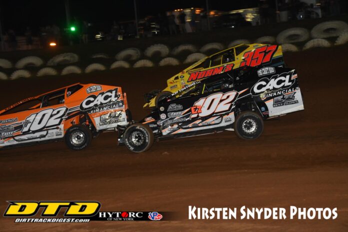 Two dirt track racers competing