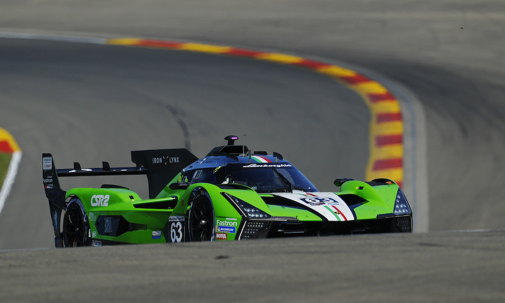 Green Cadillac race car at track