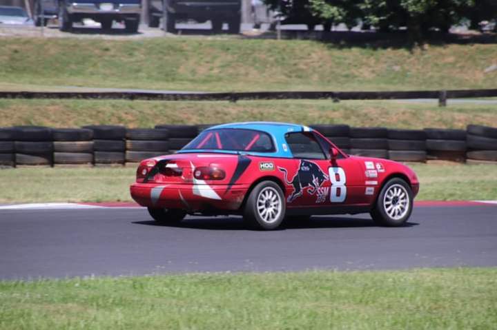 Red Spec Miata racing on track