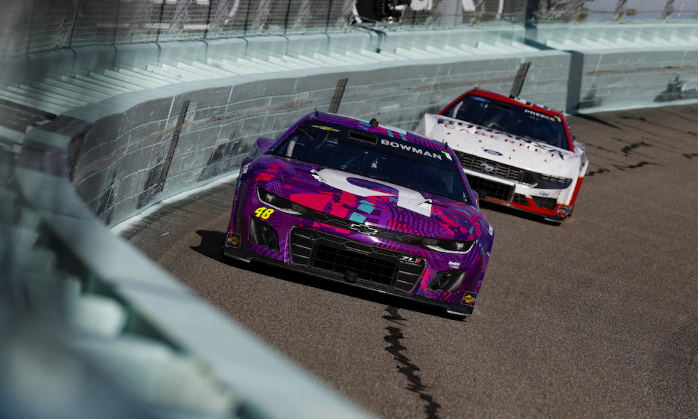 Two NASCAR cars racing side-by-side