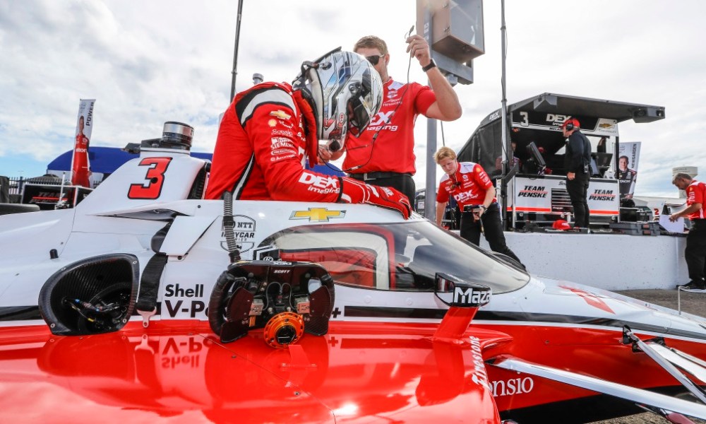 IndyCar pit crew servicing car