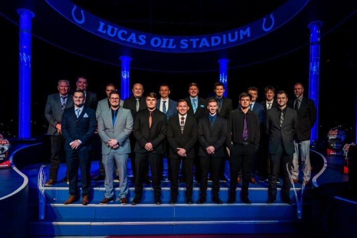 Men stand on presentation stage