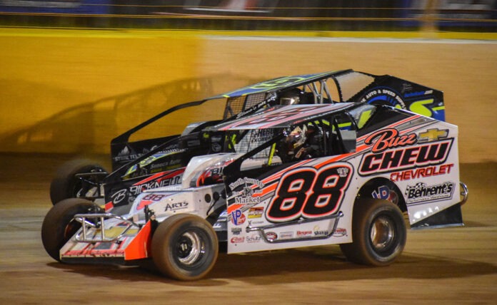 Two dirt track racers competing