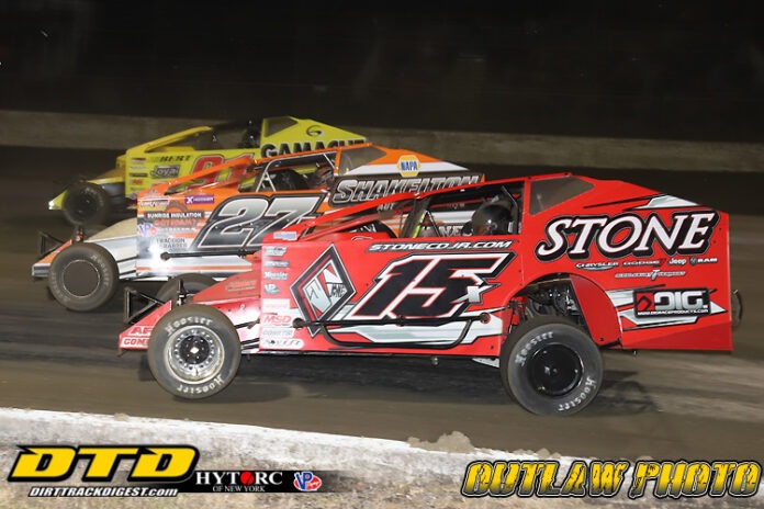 Two dirt track racers competing