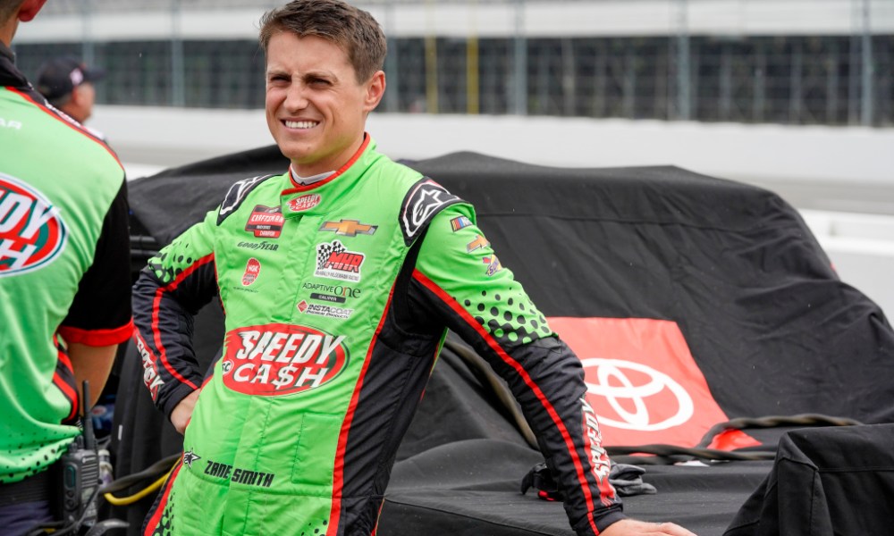 Zane Smith beside covered Toyota racecar