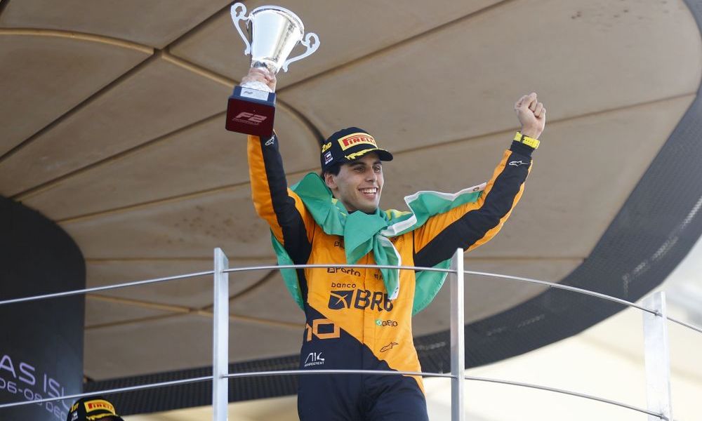 Man proudly holds racing trophy