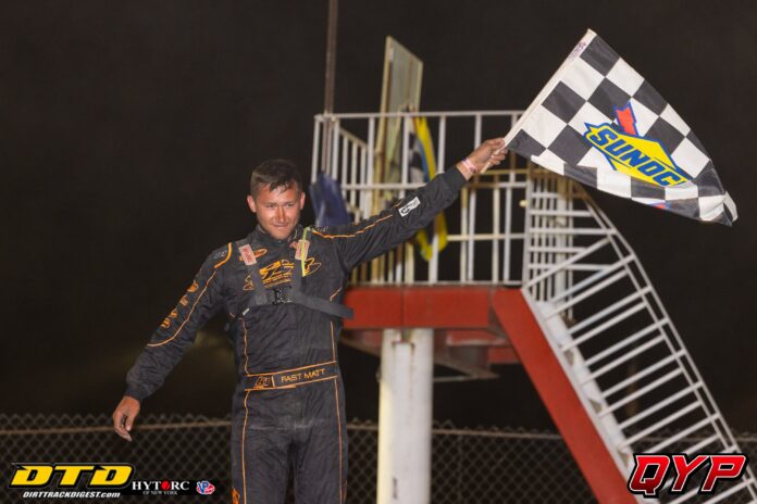 Driver celebrating with checkered flag