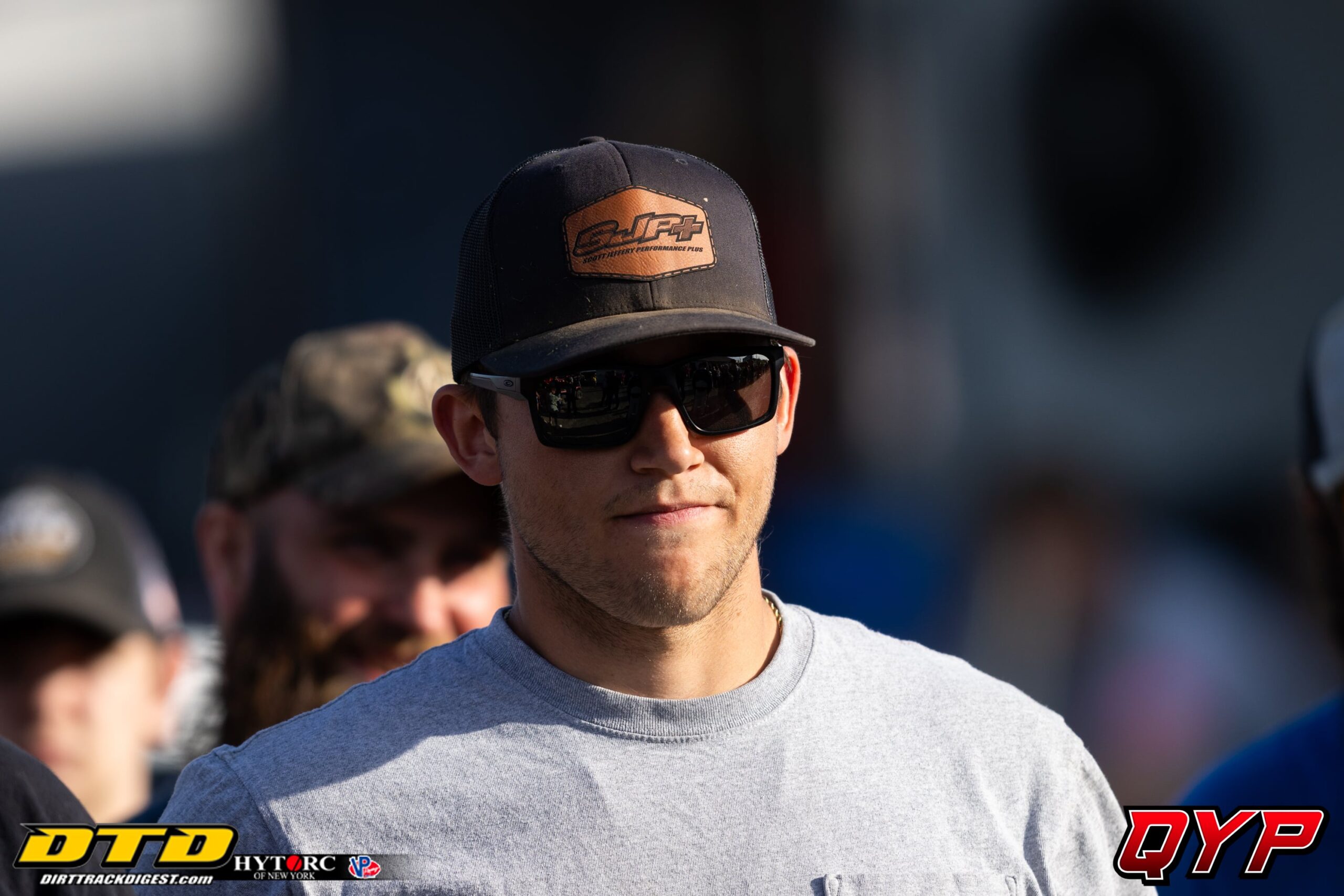 Man in cap at dirt track