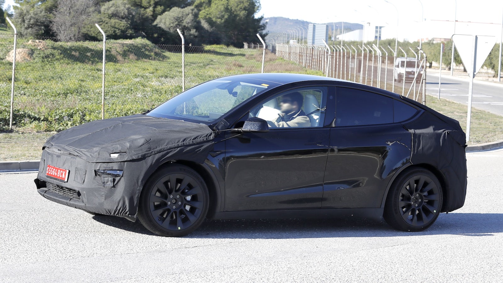 Black Tesla Model Y in motion