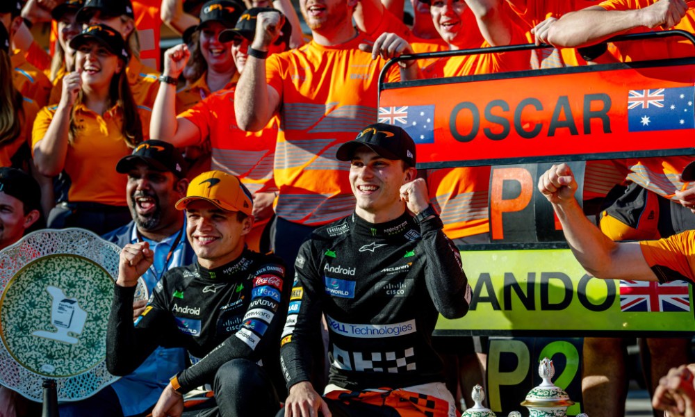 Two racers celebrate victory trackside