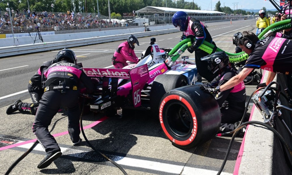 Pink IndyCar on racetrack