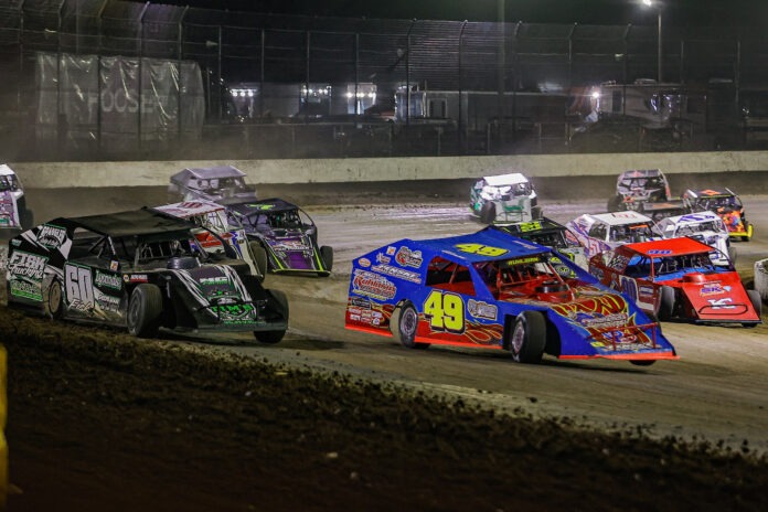 Modified racecars racing on dirt track