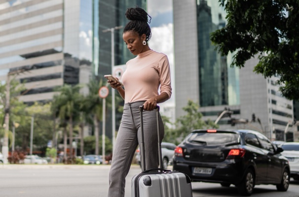 Woman checks phone by luggage