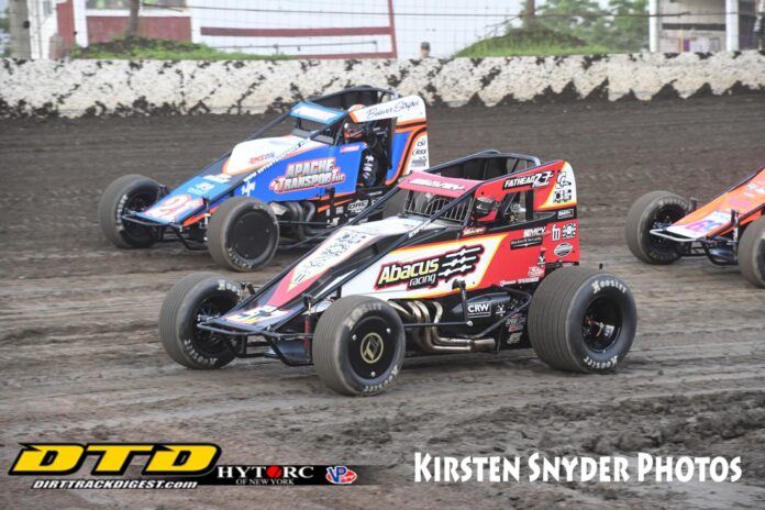 Sprint cars racing on dirt track