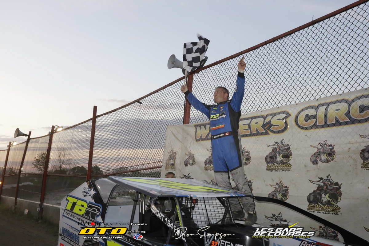 Racer celebrating with flag on car