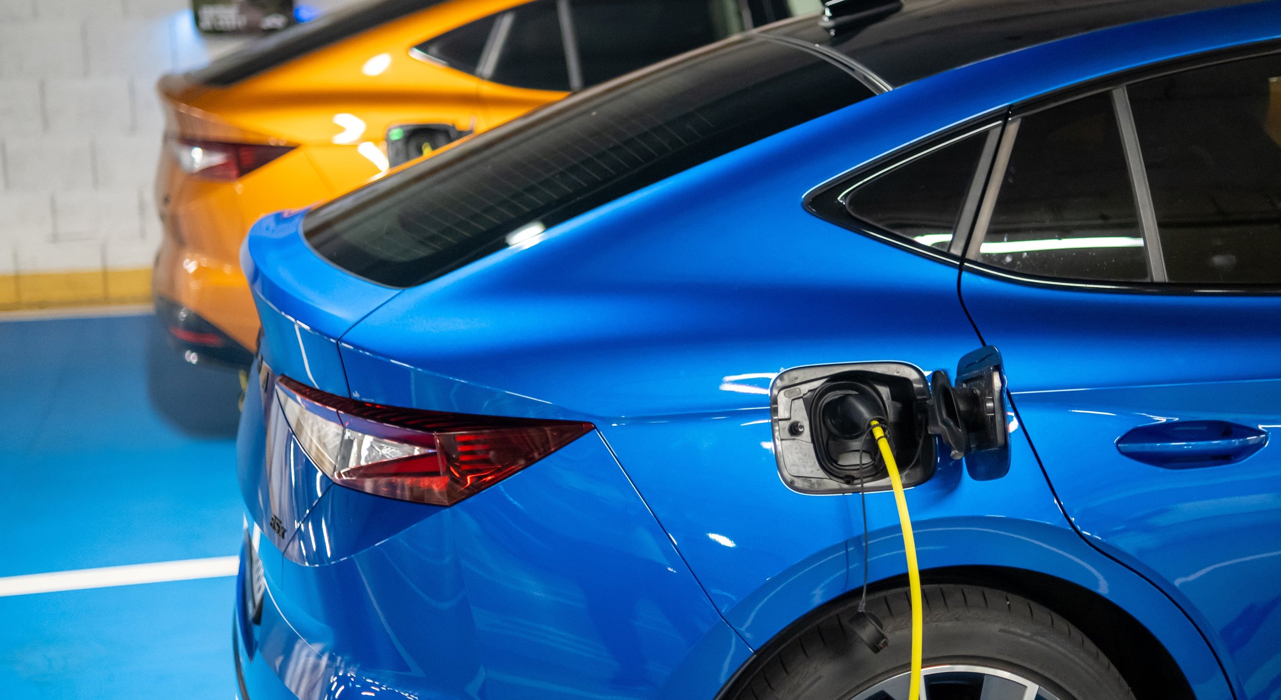 Two EVs charging in garage