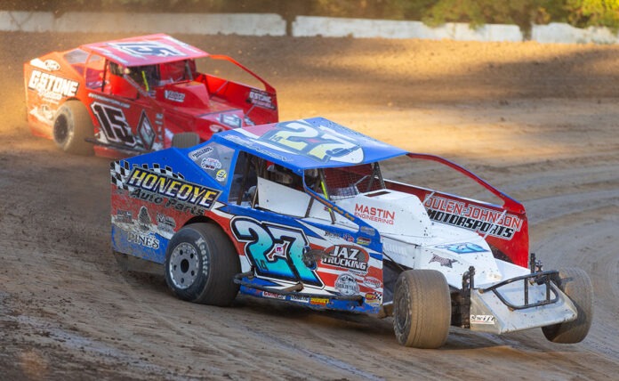 Two dirt track racers competing