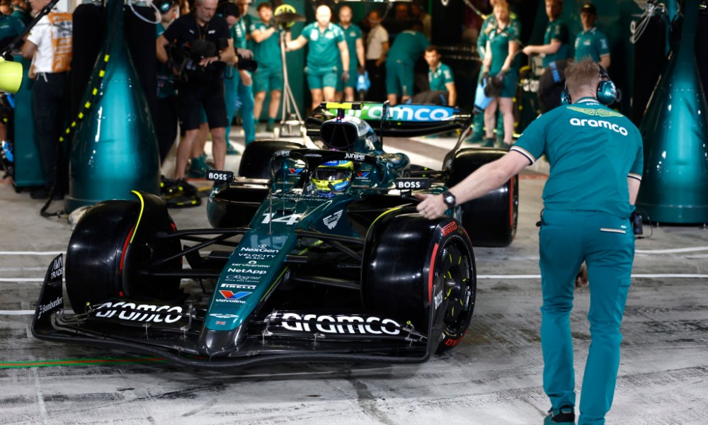 Man in teal suit walking forward