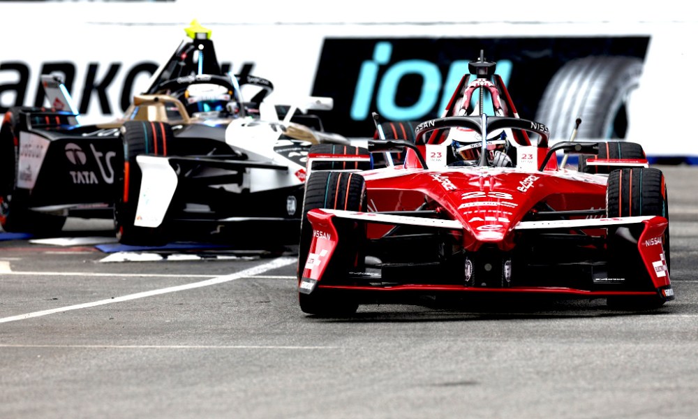 Red race car cornering on racetrack