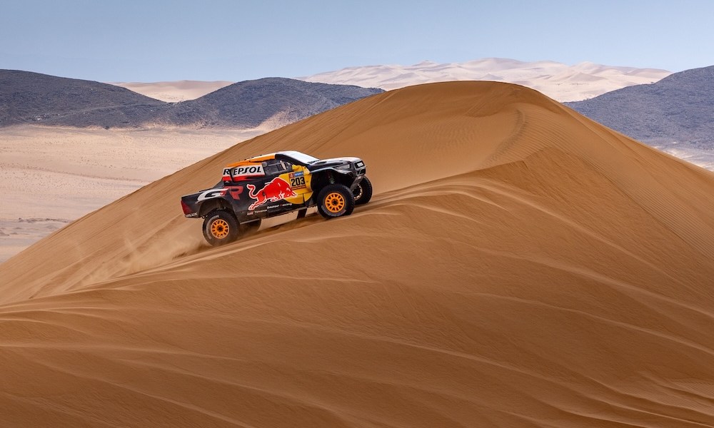 Trophy truck racing through desert terrain