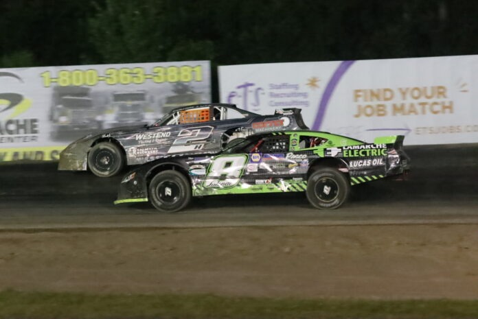 Two dirt track racers competing