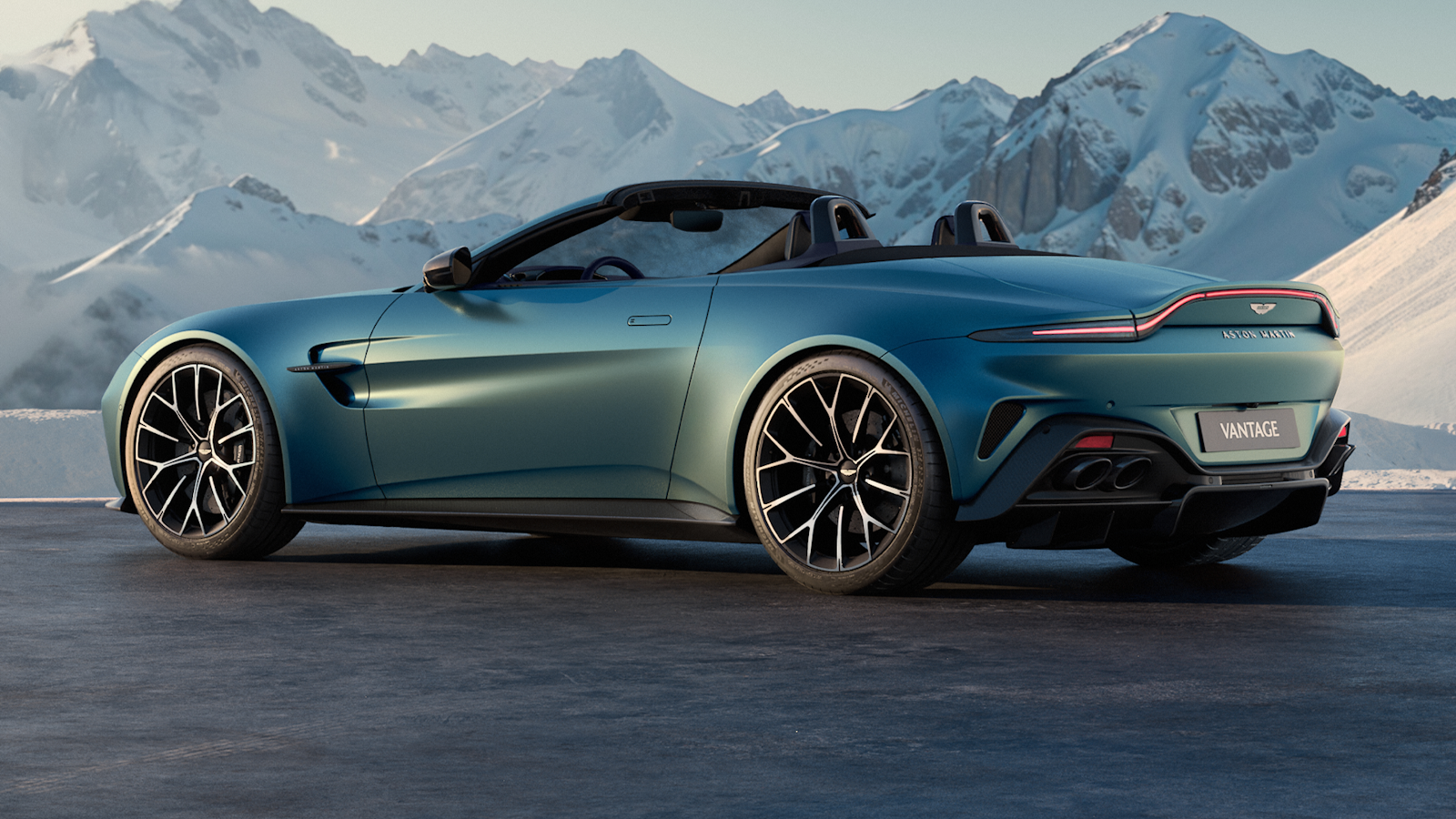 Blue Aston Martin Vantage in mountains