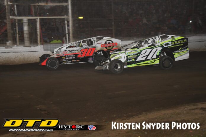 Two sprint cars racing on dirt