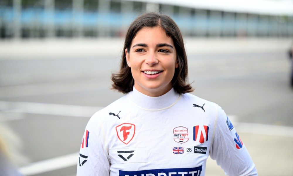 Smiling female racer in racing suit