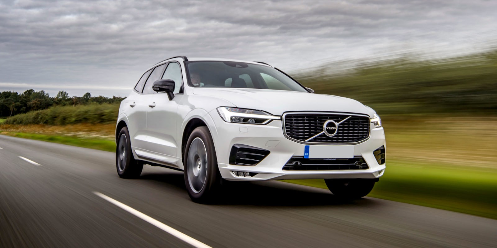 White Volvo XC60 driving forward