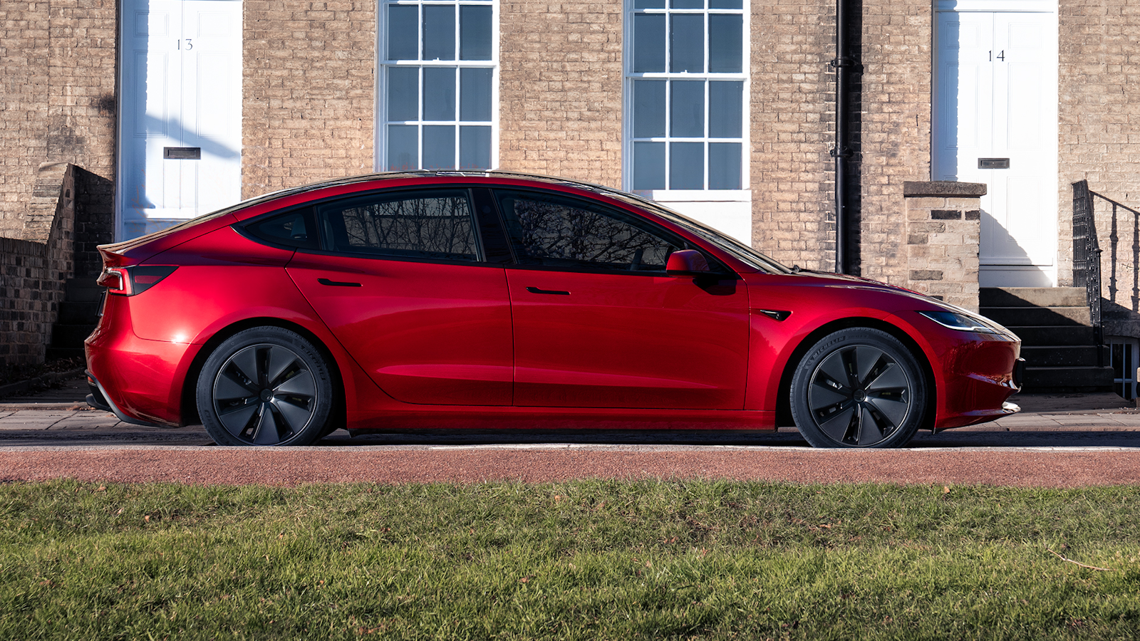 Red Tesla Model 3 parked