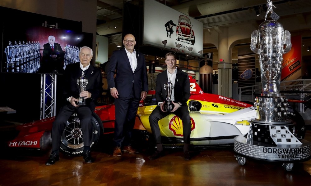 Three men present racing trophy ceremony