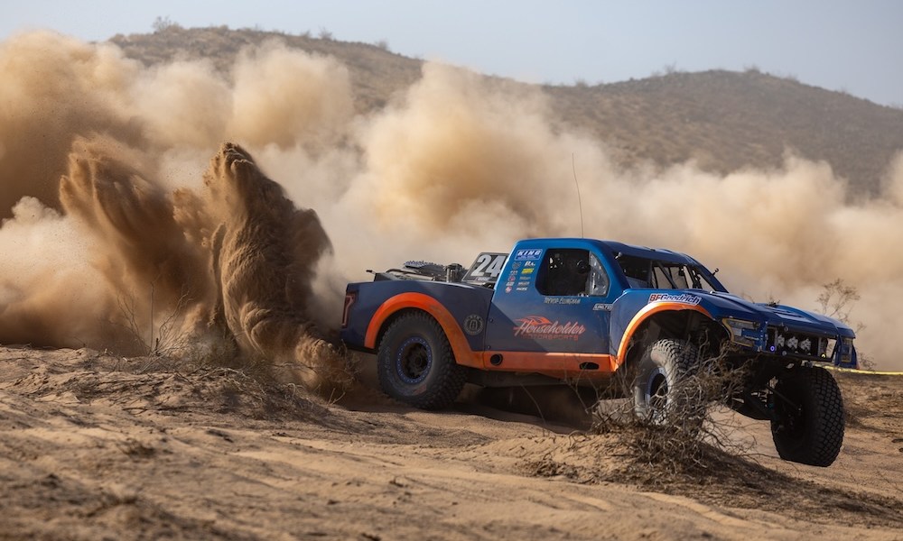 Off-road truck racing through desert