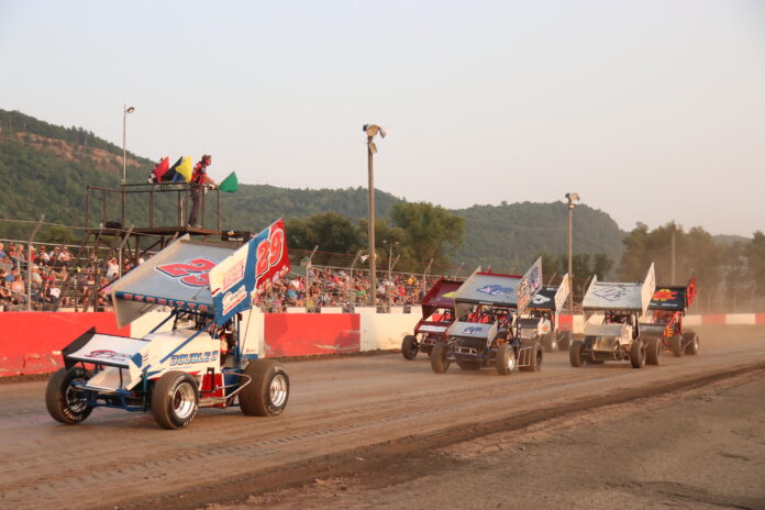 Sprint cars racing on dirt track